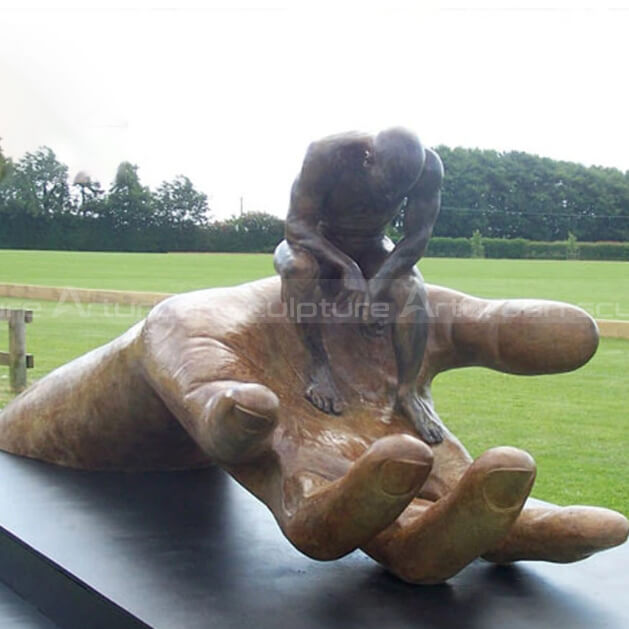 man sitting on hand statue