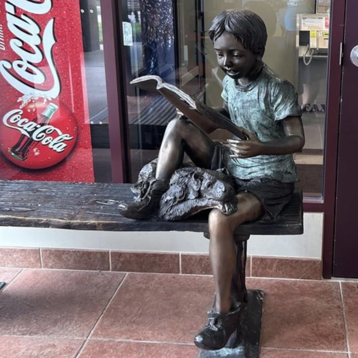 Boy Reading with Dog Statue