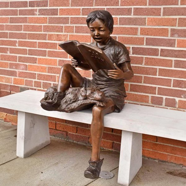 Boy Reading with Dog Statue