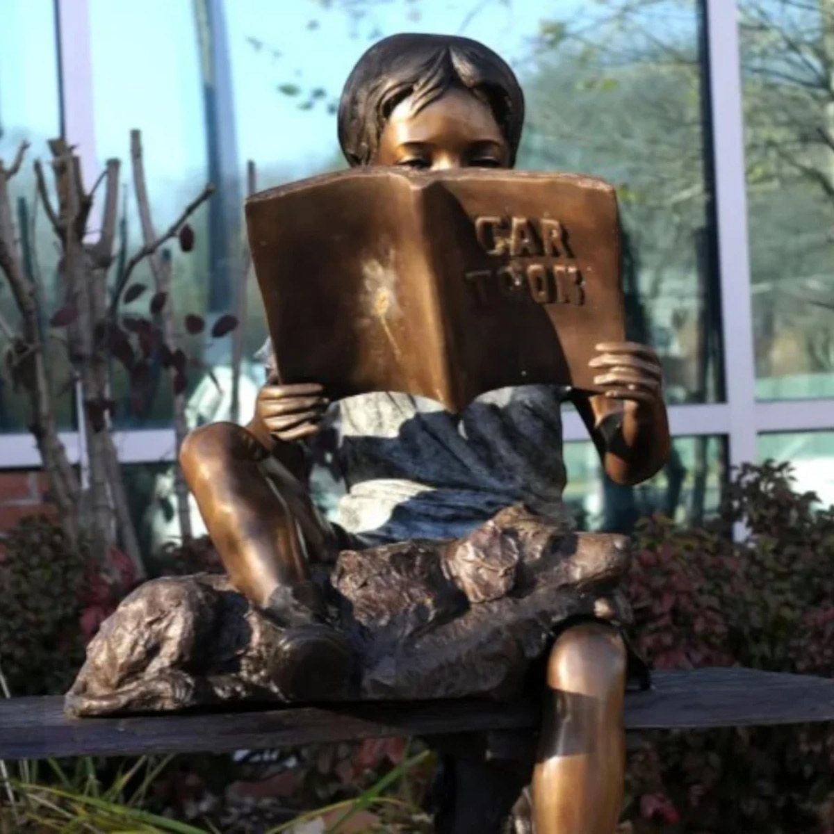 Boy Reading with Dog Statue